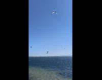 Kite surfer takes flight and lands safely on water