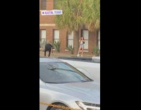 White shirt girl poses curb parking lot 