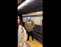 man in brown jacket wears face mask on forehead