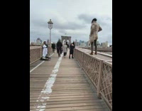 Woman stands on bridge skyline picture