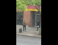 Pedestrian stops to dance with performer 