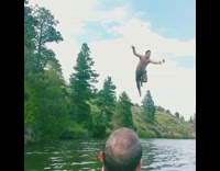 Guy swings from rope into lake while catching drink 