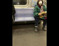 All passengers on subway are reading book at same time
