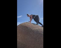 Girls take photo with desert rocks