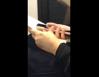 Girl with shower written on her hand subway train