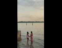Two girls dance in water