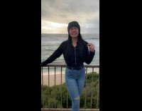 Woman smiles with sad face filter beach