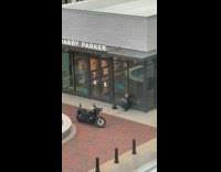 Guy photographs black motorcycle warby parker 