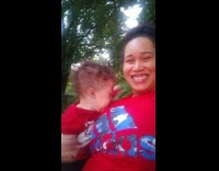Toddler boy cries in moms arms 