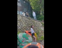 Man in white top poses in front of the pool party