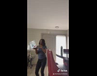 Blue shirt girl entrepreneur dances laptop balcony 