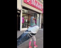 Person in large pigeon costume on sidewalk