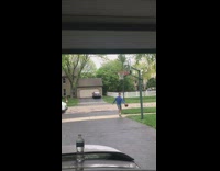 Mailwoman cheers on kid playing basketball dunk