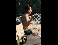 Shirtless guy sticks tongue out and raises arms up 