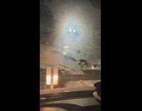 Lamppost in the parking lot with blue light around it