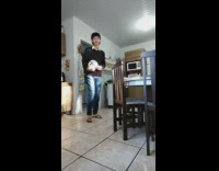 Guy tries to do soccer kicks in kitchen 