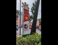 Woman with bread poses side of street