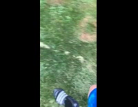 Guy gives black dog behind fence treat 