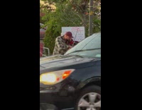 Guy plays electric violin in parking lot 