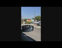 guy drives past man on electric scooter on a cellphone 