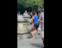 Woman hits spatula on fountain