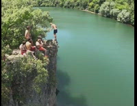 Guy backflips off rock cliff green lake 