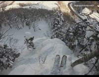 Guy skis down steep mountain and face plants into snow, helmet Go pro camera