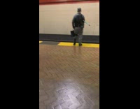 Girl walks by guy peeing on tracks 