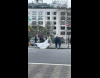 Woman wavers a white blanket behind her