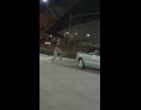 Man silver gray track suit dance gray car
