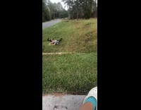 Kid rides scooter razor down driveway, hits a rock and flies off into grass