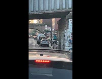 Random guy rides giraffe unicycle on road