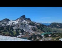 Guy goes down mountain slides on snow