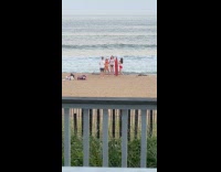 Women poses with red surfboard at beach Part 2