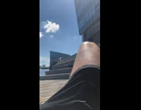 White shirt guy sits takes selfie water