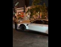 White car crash over concrete barrier