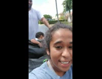 Husband pushes wife and kids on toy electric car after it breaks down with wheelchair