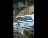 Policeman in Santa Claus Costume Lays inside Car