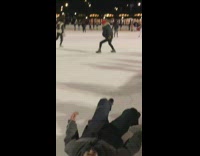 Girl falls back on ice skating rink 