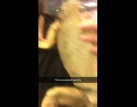 man in black shirt holding iguana