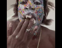 Guy with sprinkles on face eats icing with hand
