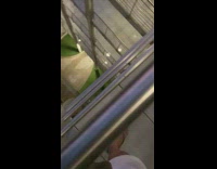 Guy from upper story in apartment kicks water down at woman below