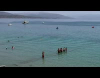 Six people lined up domino effect at the beach