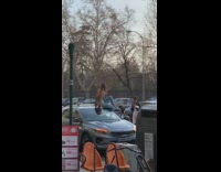 two girls on top of two cars for pictures 