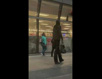 Tall woman walk on street suit bag