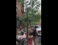 Four guys sing a cappella brick building 