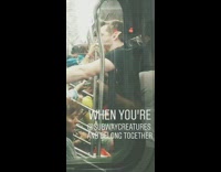 Guy with elf ear talks to woman on subway train across cars