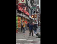 Man raps in front of a restaurant at the sidewalk