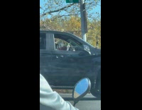 Fake skeleton holding up middle finger inside car