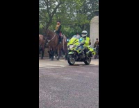 Guards on horses drag wheeled cart street